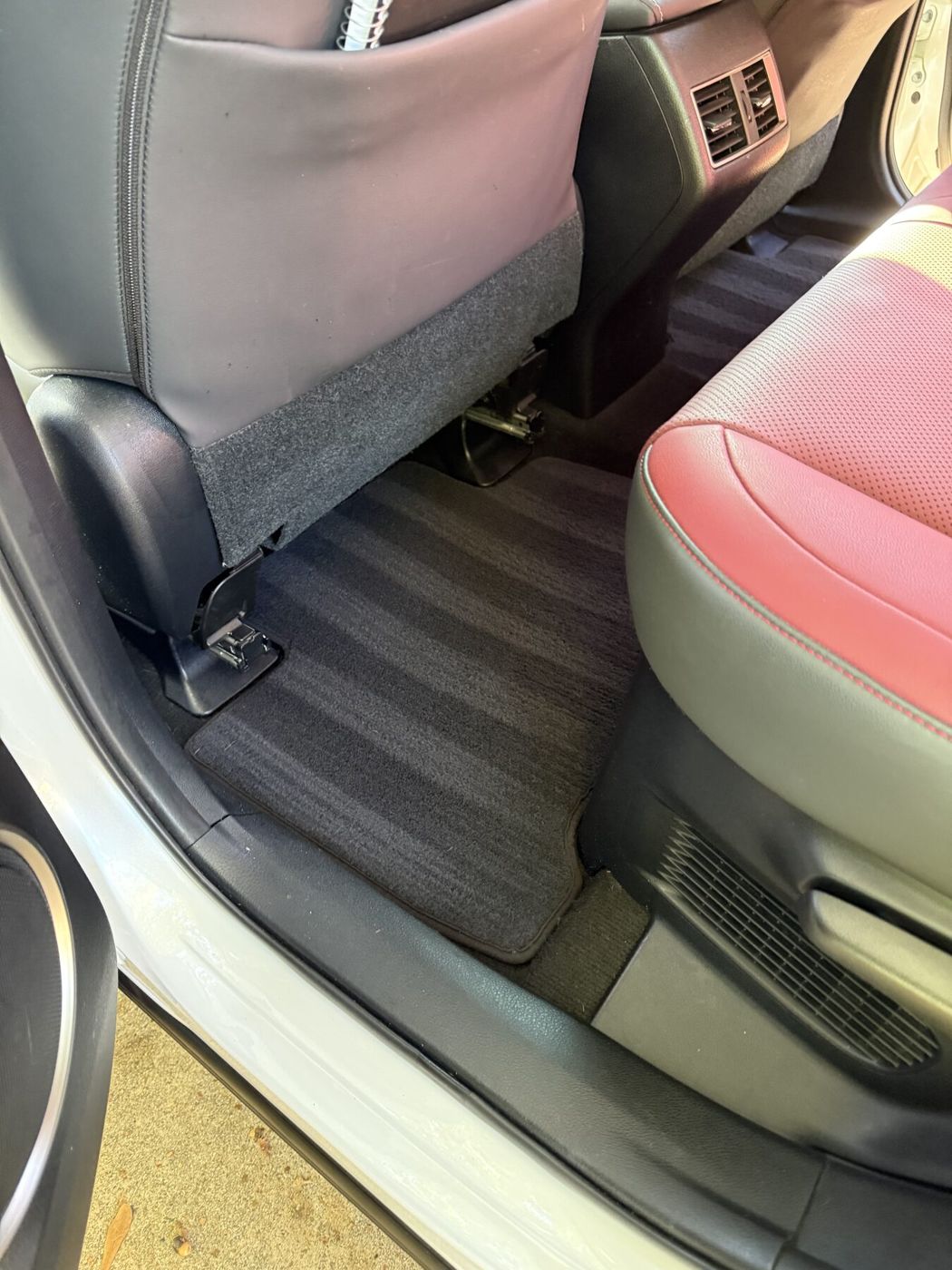 Rear floor of a car after detailing, carpet vacuumed with straight lines